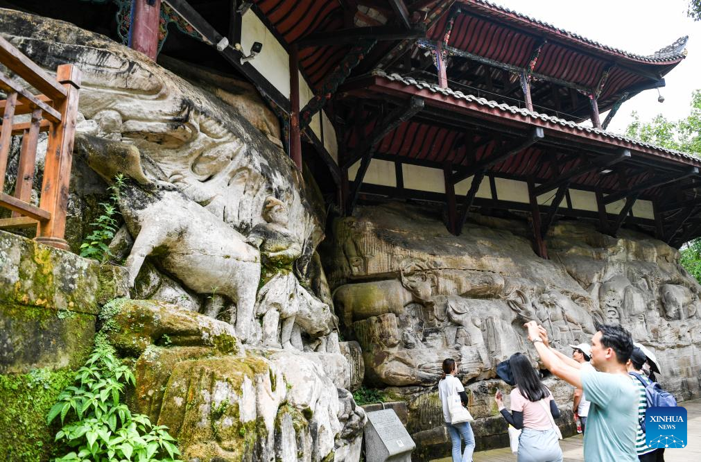 Tourists visit scenic spot of Dazu Rock Carvings in China