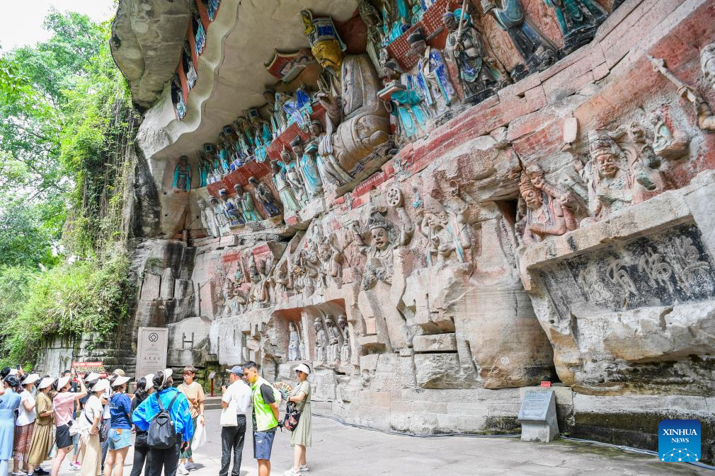 Tourists visit scenic spot of Dazu Rock Carvings in China