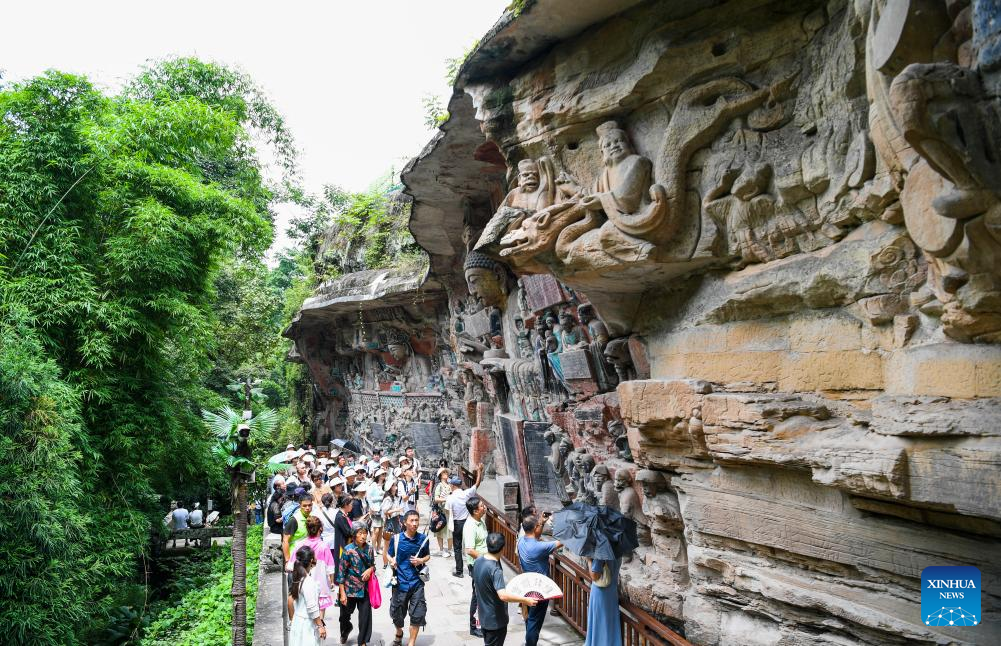 Tourists visit scenic spot of Dazu Rock Carvings in China